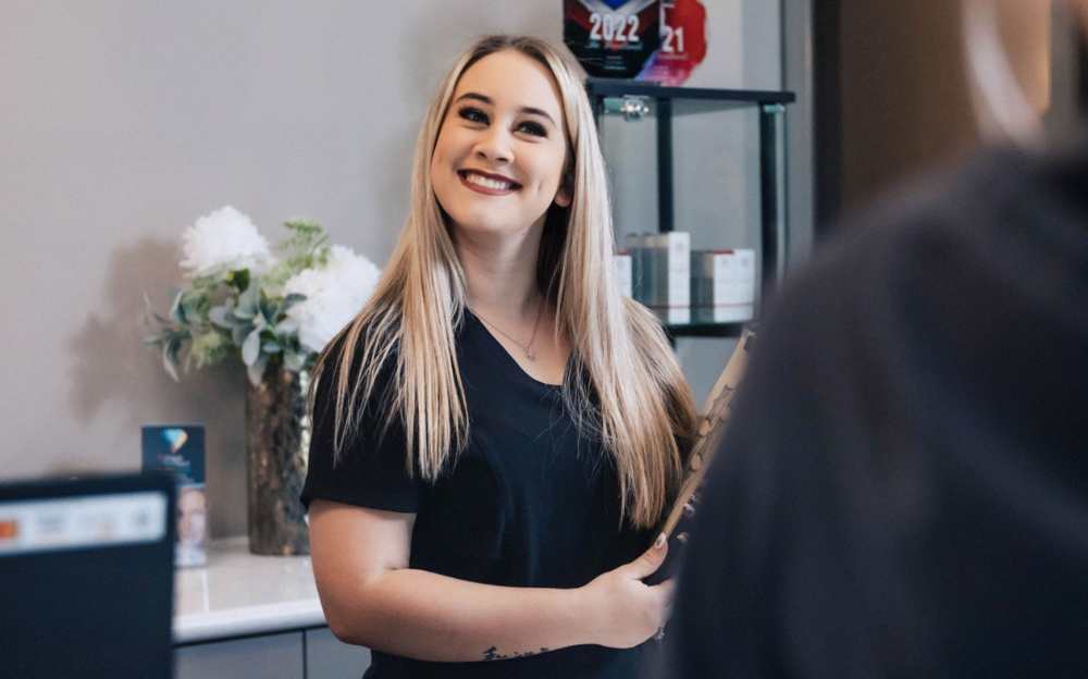 Bethany smiling at the front desk